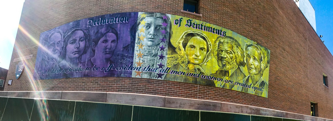 Banner with suffragists on a brick building