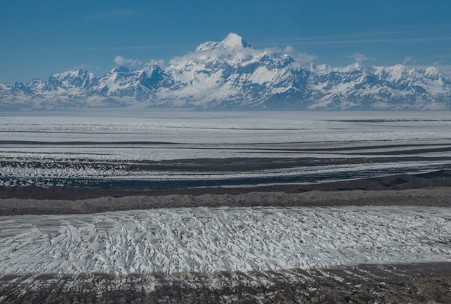 WRST_MALA_240616-047_crop_web A glacier in the foreground with the mountains where it originated in the background.