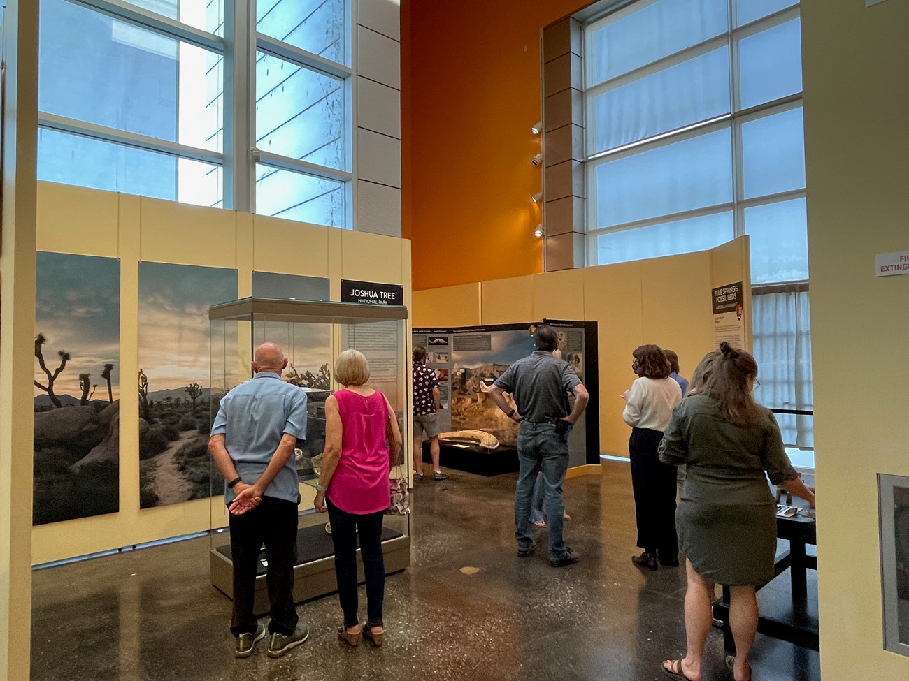 Photo of a group of people standing inside of a visitor center buildding
