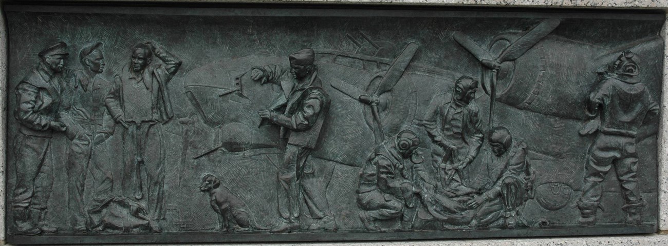 Bronze relief of a World War II bomber scene