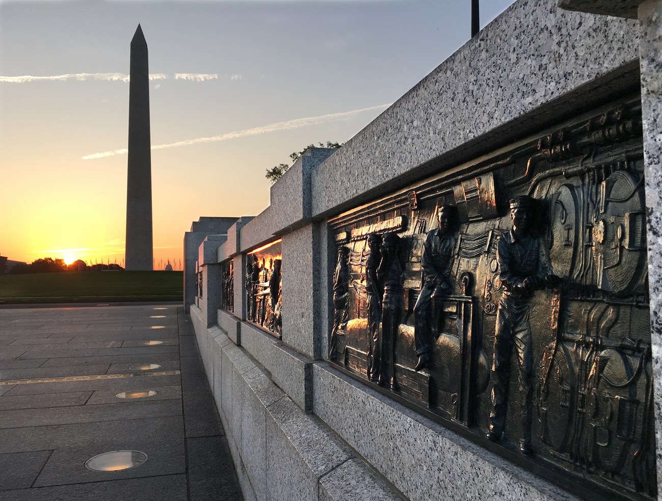 World War II reliefs and Washington Monument at sunrise