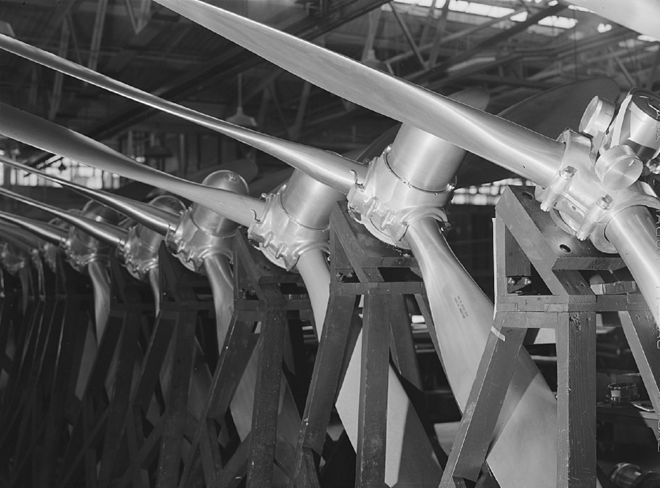 large shaped metal airplane propellers stand in a row