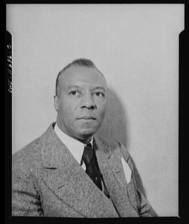 Portrait of A. Philip Randolph seated, looking to his right.