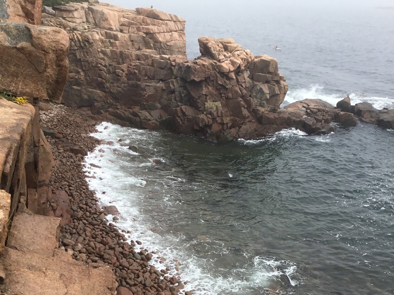 Waves breaking on the boulder covered shoreline