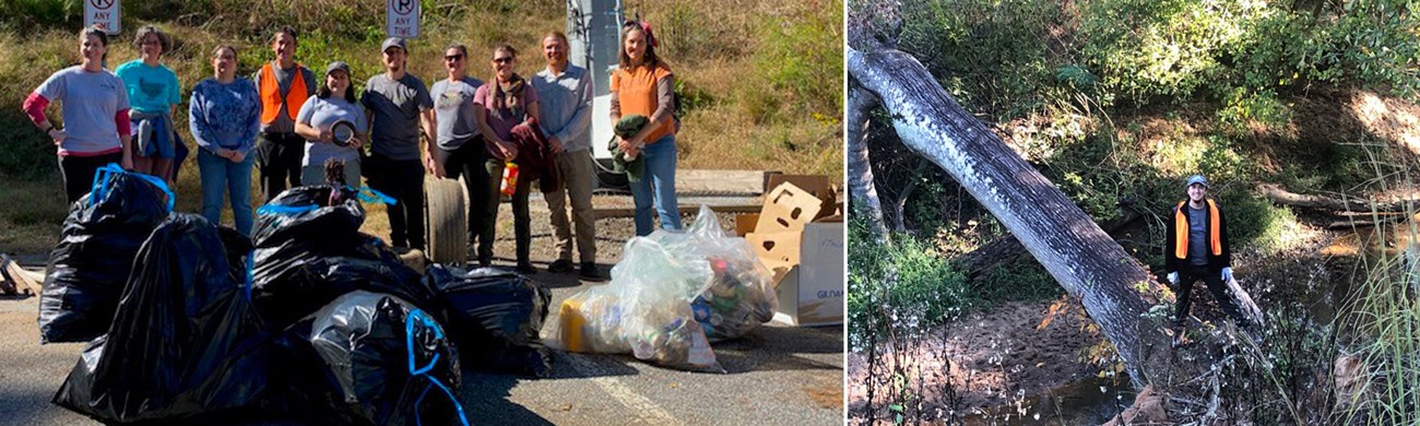 Group of people standing behind bags of trash and a man standing on a tree over a river.