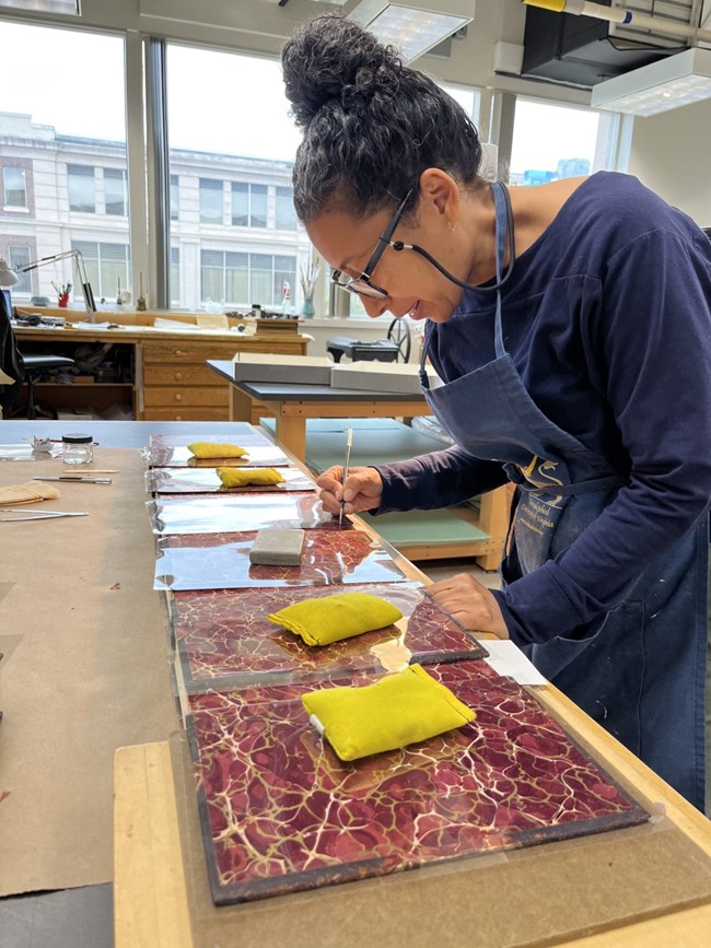Conservator treating book