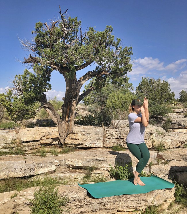 Girl Sitting on Rock by Water Falls Yoga Mat