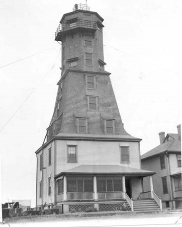 a tall, historic tower above a residential building