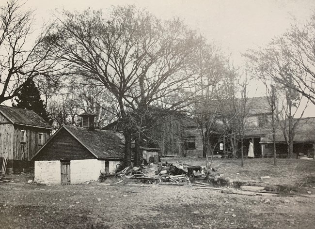 White Haven 1916 Black and white photo of a rural landscape. An ice house and chicken house are in the foreground while a two story frame house is in the background.