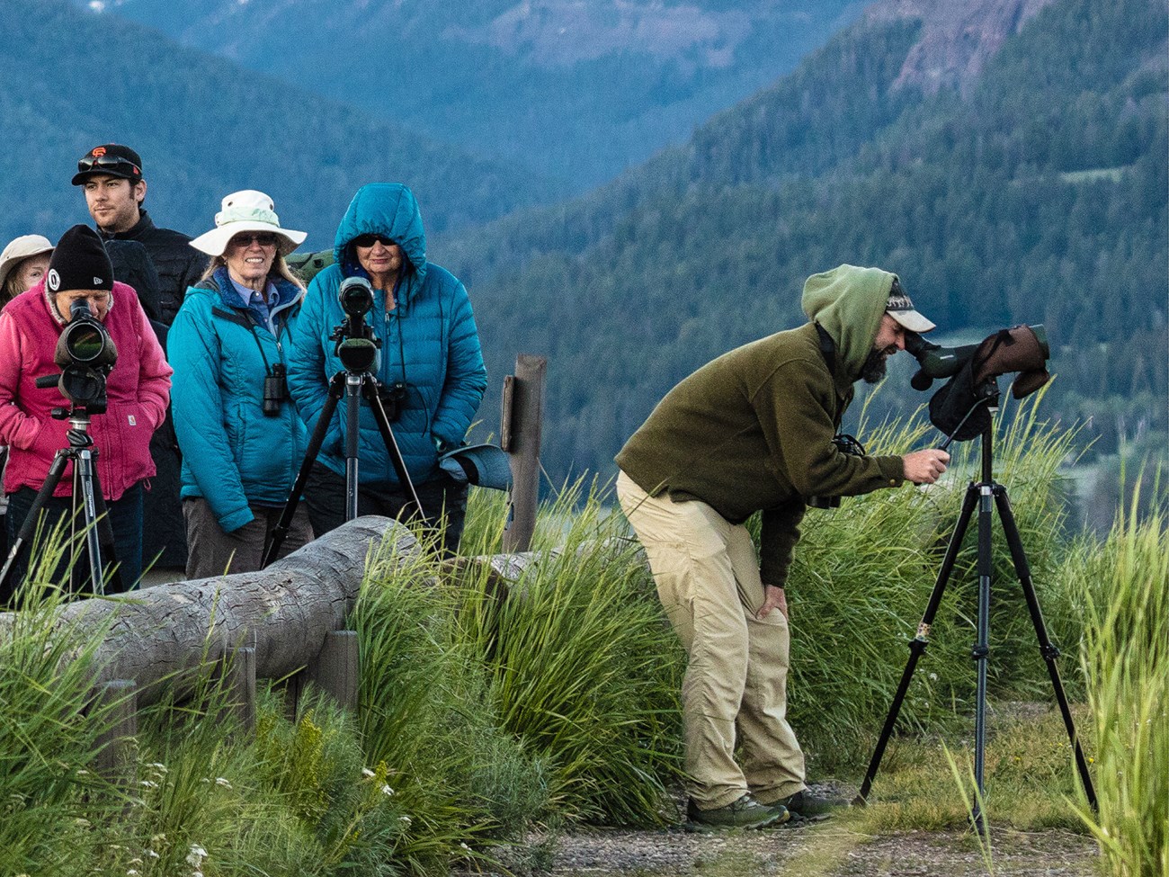 A group of visitors with spotting scopes