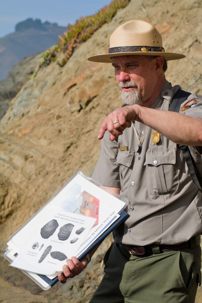 Dr. Will Elder, paleontologist and visual information specialist. Park ranger gestures to fossil diagram.