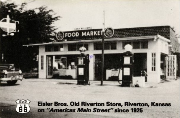 Historic black and white image of a store front.
