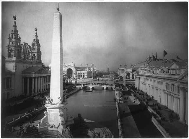 Black and white photo of several buildings surrounding a canal