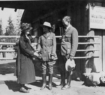 Ranger Frieda Nelson in uniform shakes hands with Governor Nellie T. Ross (left).