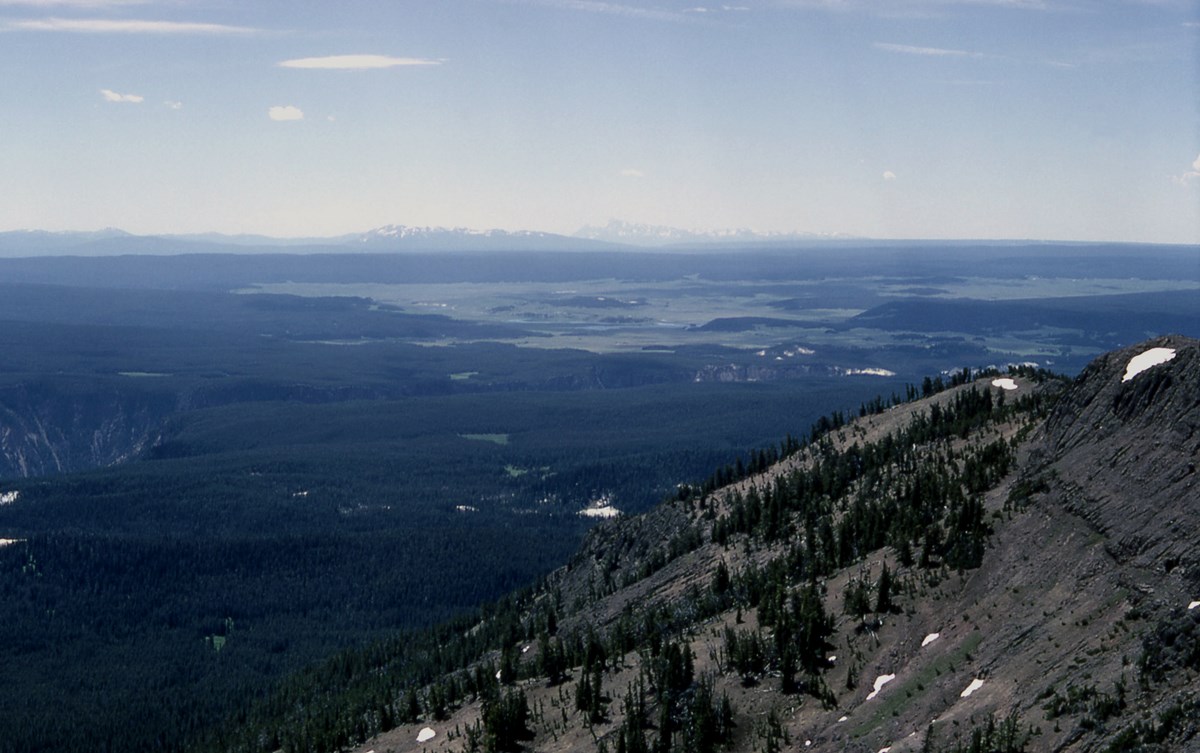 YELL supervolcano caldera plateau and lake View overlooking extensive flat ground covered with trees and meadows