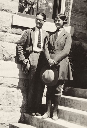 YELL93081_cropped_1921 Ranger Marguerite Lindsley in the prescribed uniform for temporary rangers stands holding her hat.