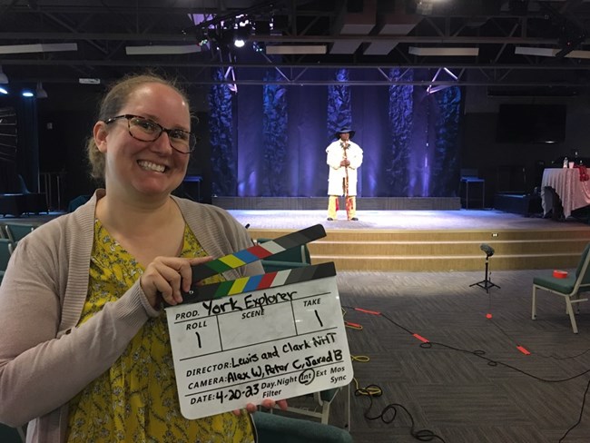 Woman holding a movie clapperboard