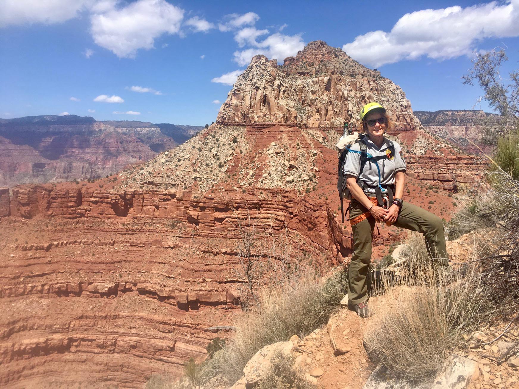 Ranger Delia Yurcik standing on an a canyon ledge