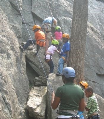 Youth and chaperone rock climbing.