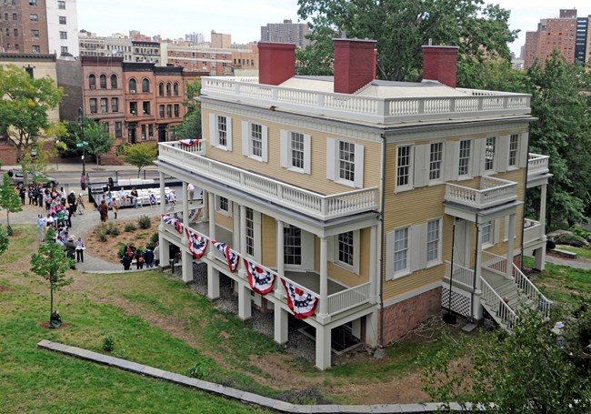 The Grange at an angle, revealing the symmetry of the windows, porches, and chimneys.