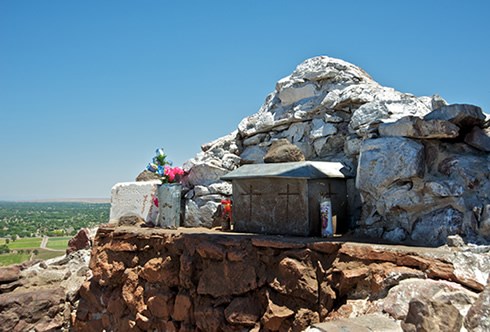 Pilgrims and hikers frequently leave objects of spiritual and personal meaning at a masonry shrine atop El Cerro de Tomé. Photo © Jack Parsons Pilgrims and hikers frequently leave objects of spiritual and personal meaning at a masonry shrine atop El Cerro de Tomé. Photo © Jack Parsons