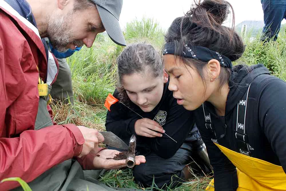 Arch Camp cover An archaeologist shows kids a soil core.