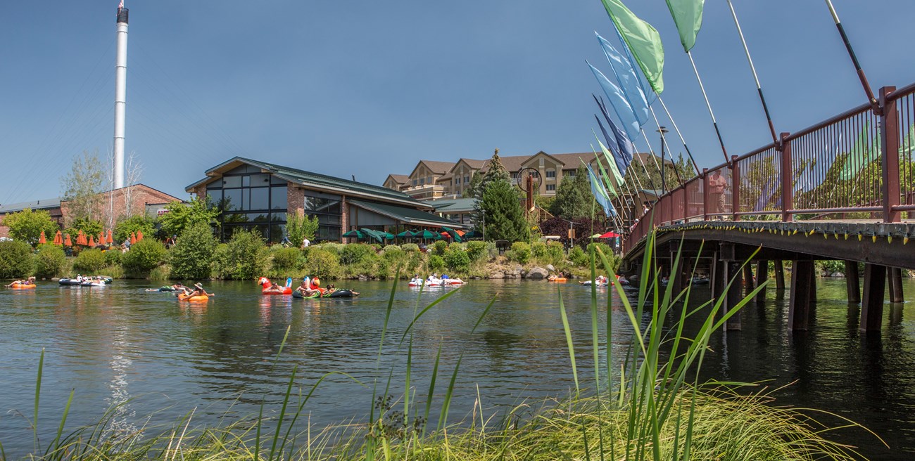 Deschutes River Kayakers float under a bridge on a river