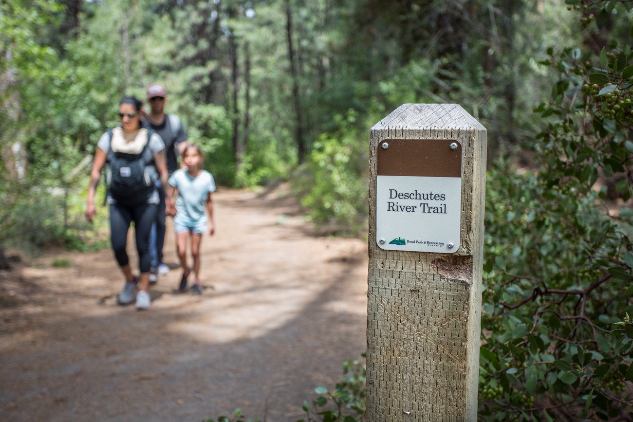 A family hiking on the Deschutes River Trail