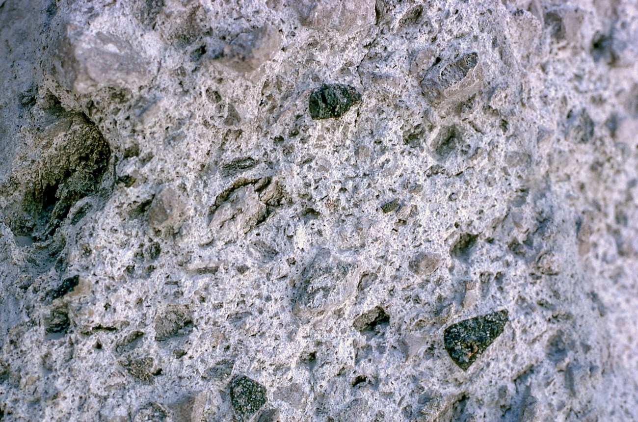 Photo of volcanic rock close-up showing fine- and course-grained materials "welded" together.