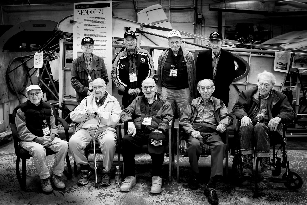 bkack and white photo of nine WWII veterans