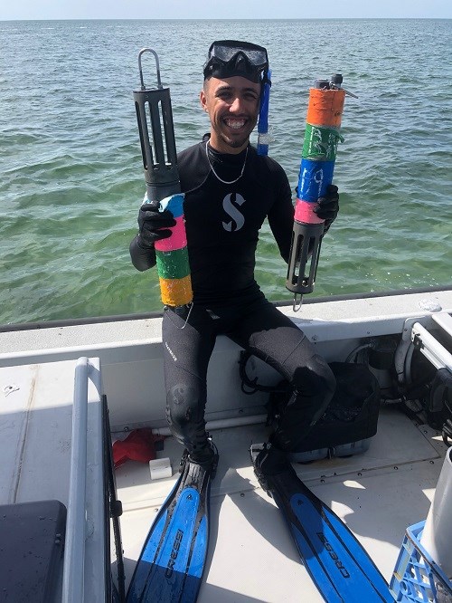 man in scuba diving suit on a boat