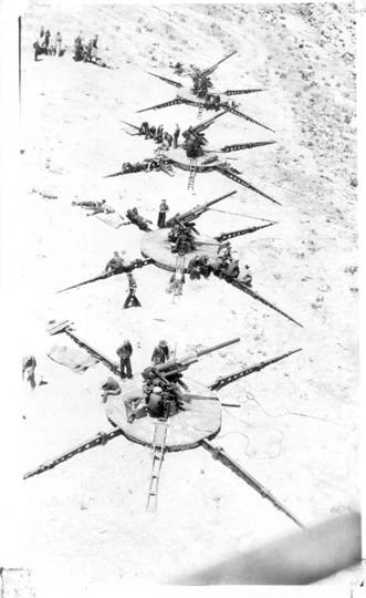 four large anti-aircraft guns stand in a line