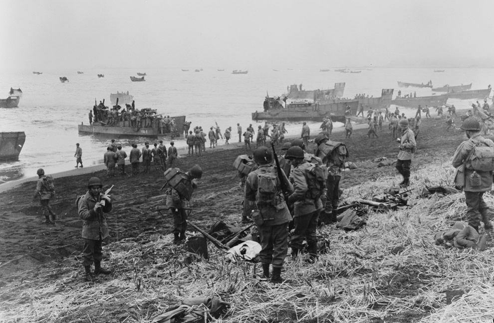 black and white photos of many men in uniform landing from boats on a beach.