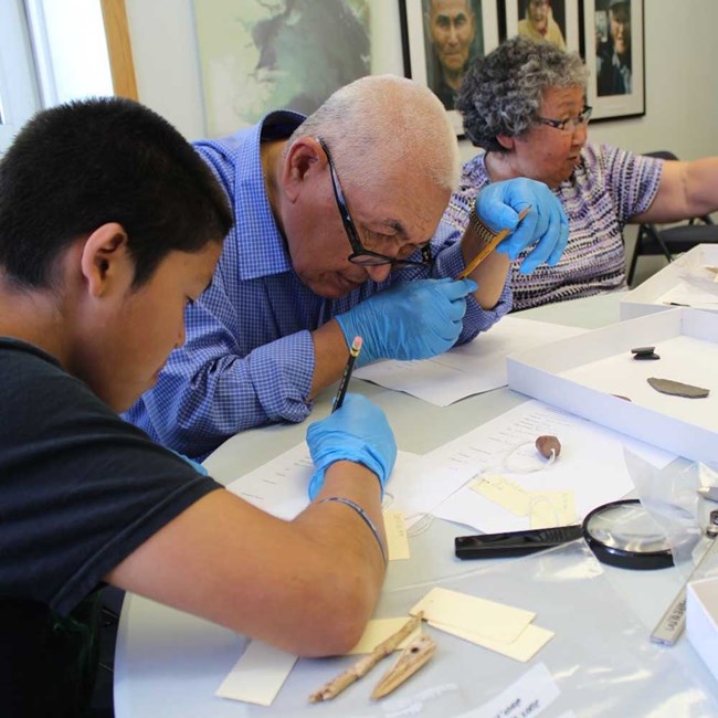 Youth and elders work together to document artifacts.