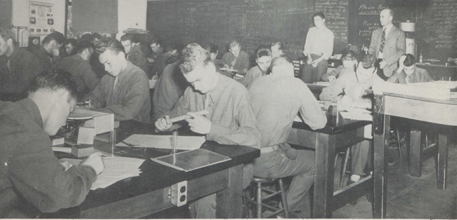 Black and white picture of army students in a classroom studying aviation.