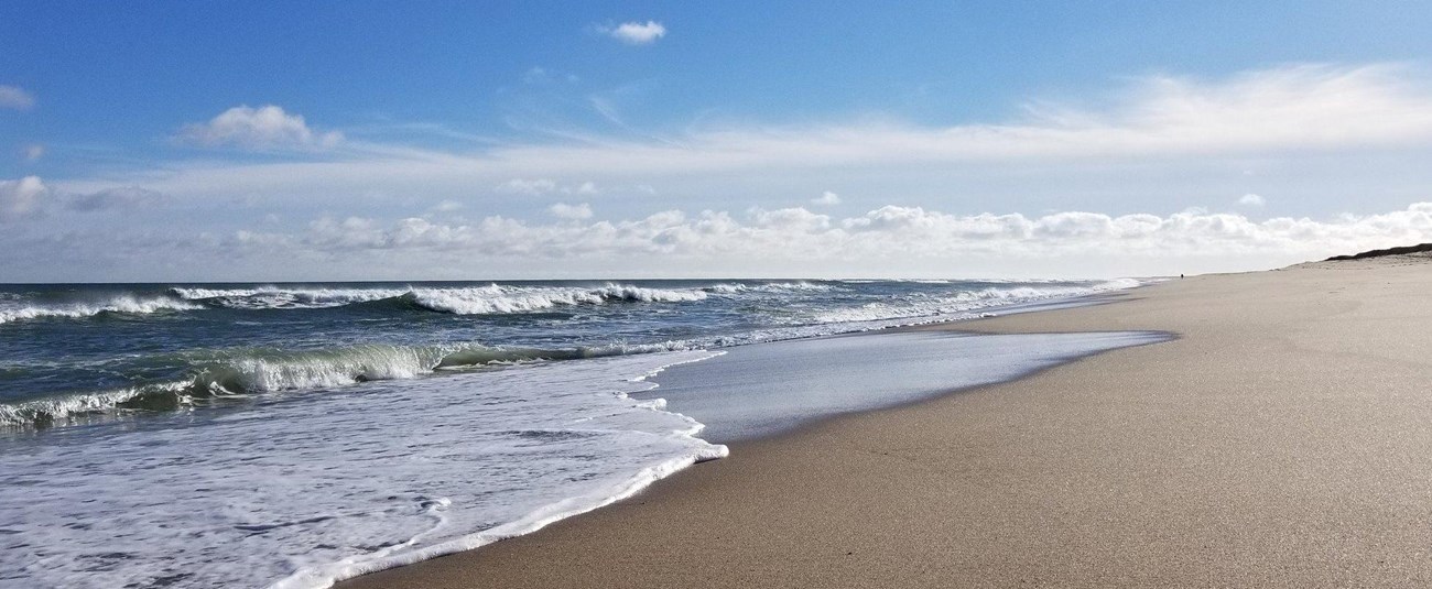 Waves lap up on the beach.