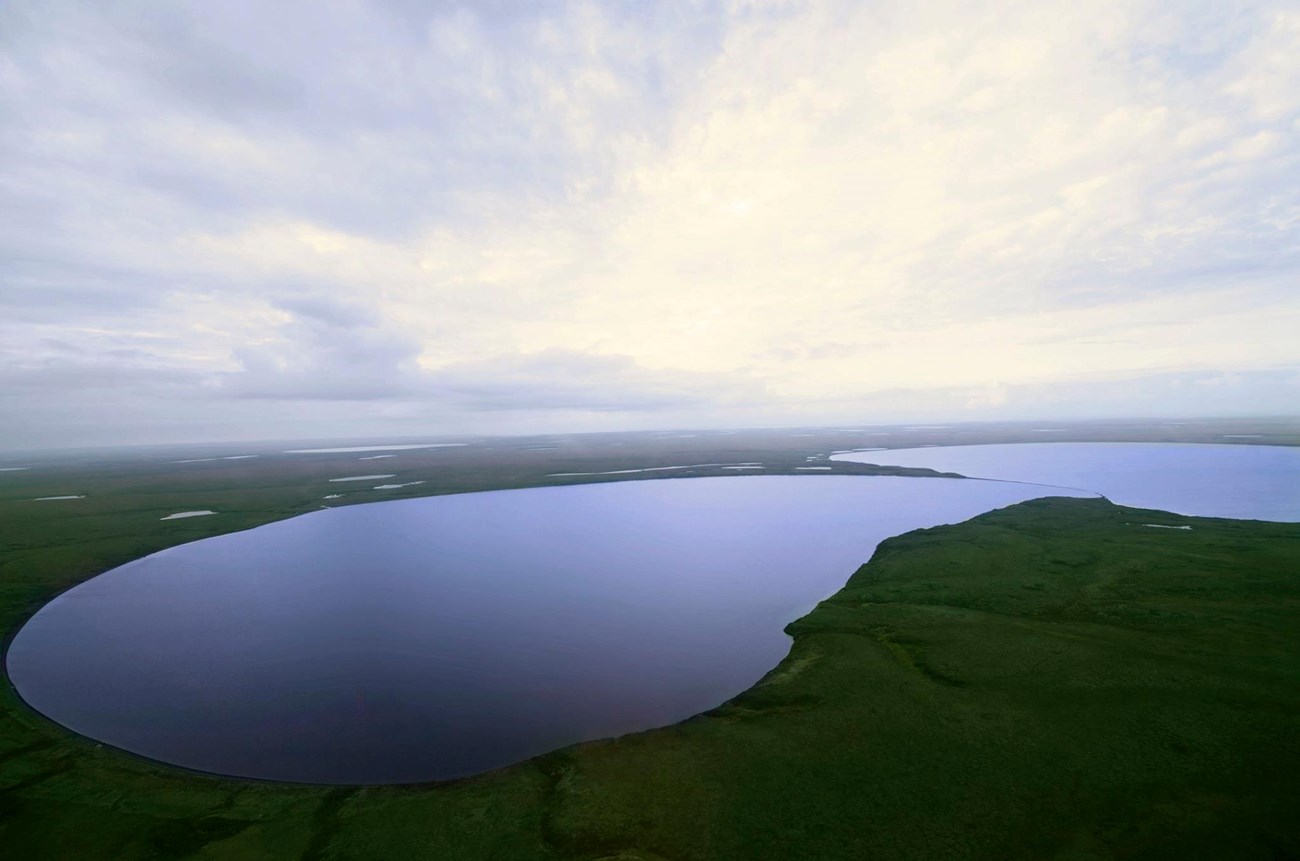 low-relief, broad crater lake