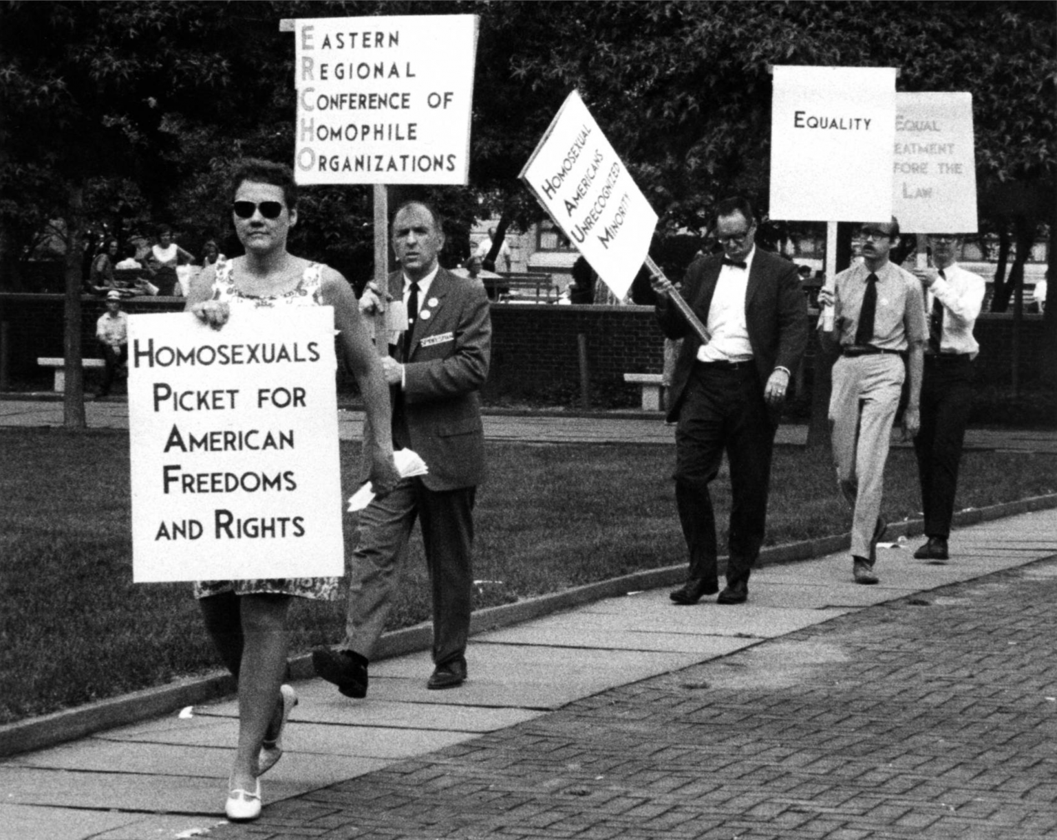 bib-to-gig-event-1536x1222 People marching with signs about LGBTQ rights