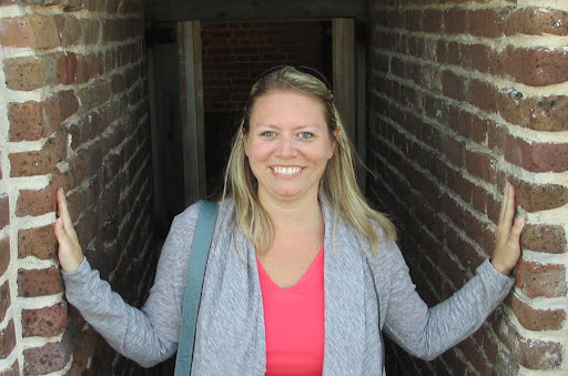 Dr. Megan Birk standing by brick walls