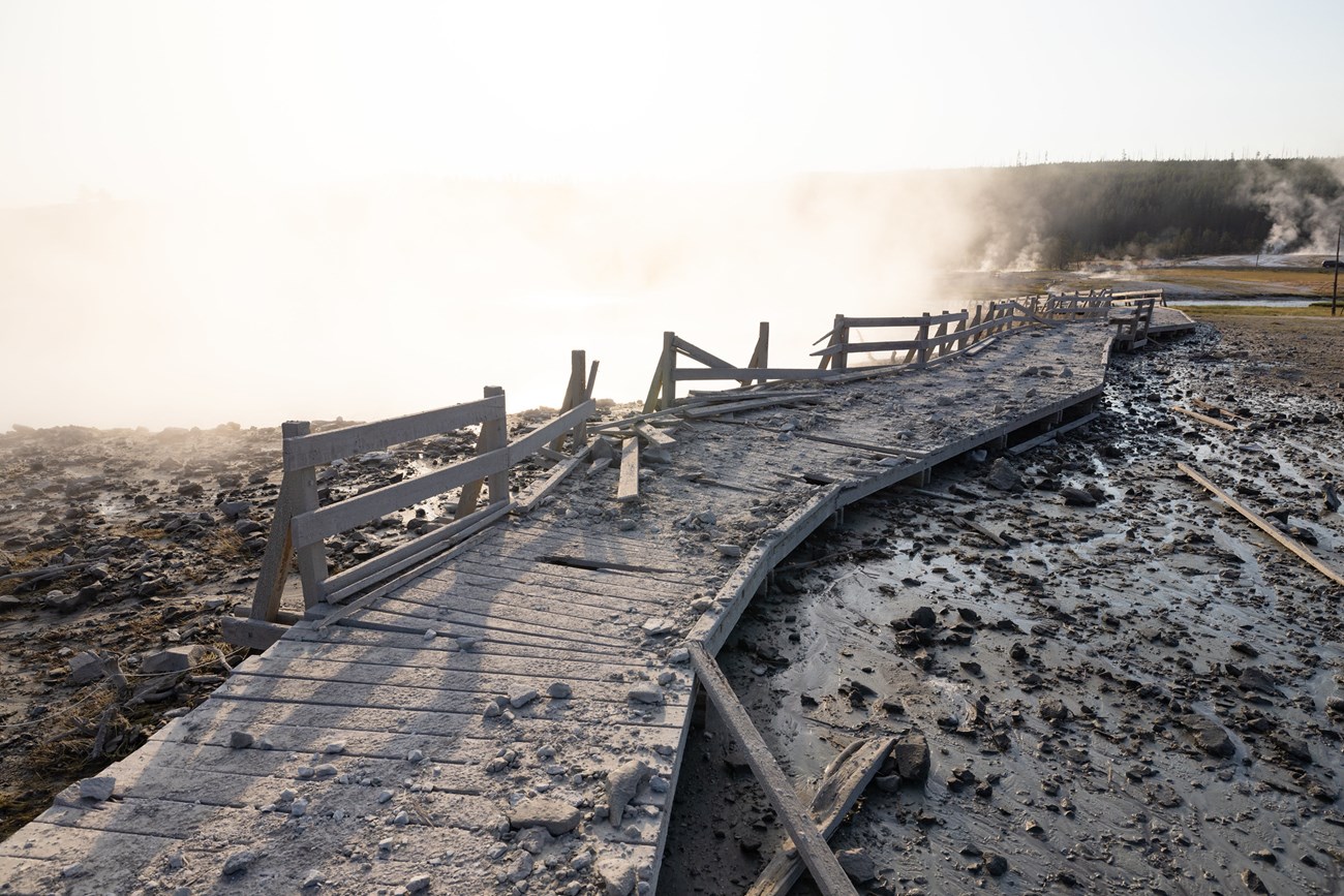 Biscuit Basin explosion a damaged boardwalk covered with rock and debris in a hydrothermal area