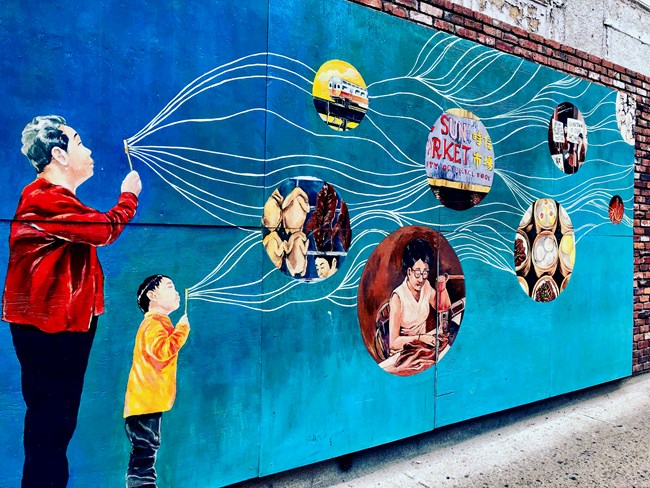 Boston Chinatown Mural Mural of man and child blowing bubbles