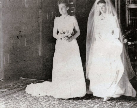 brides-mollie-garfield-stanley-brown-and-belle-mason-garfield two brides standing next to each other holding flowers