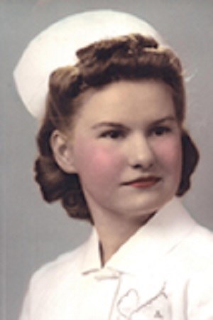 Color portrait of a young woman wearing a white nurse uniform.