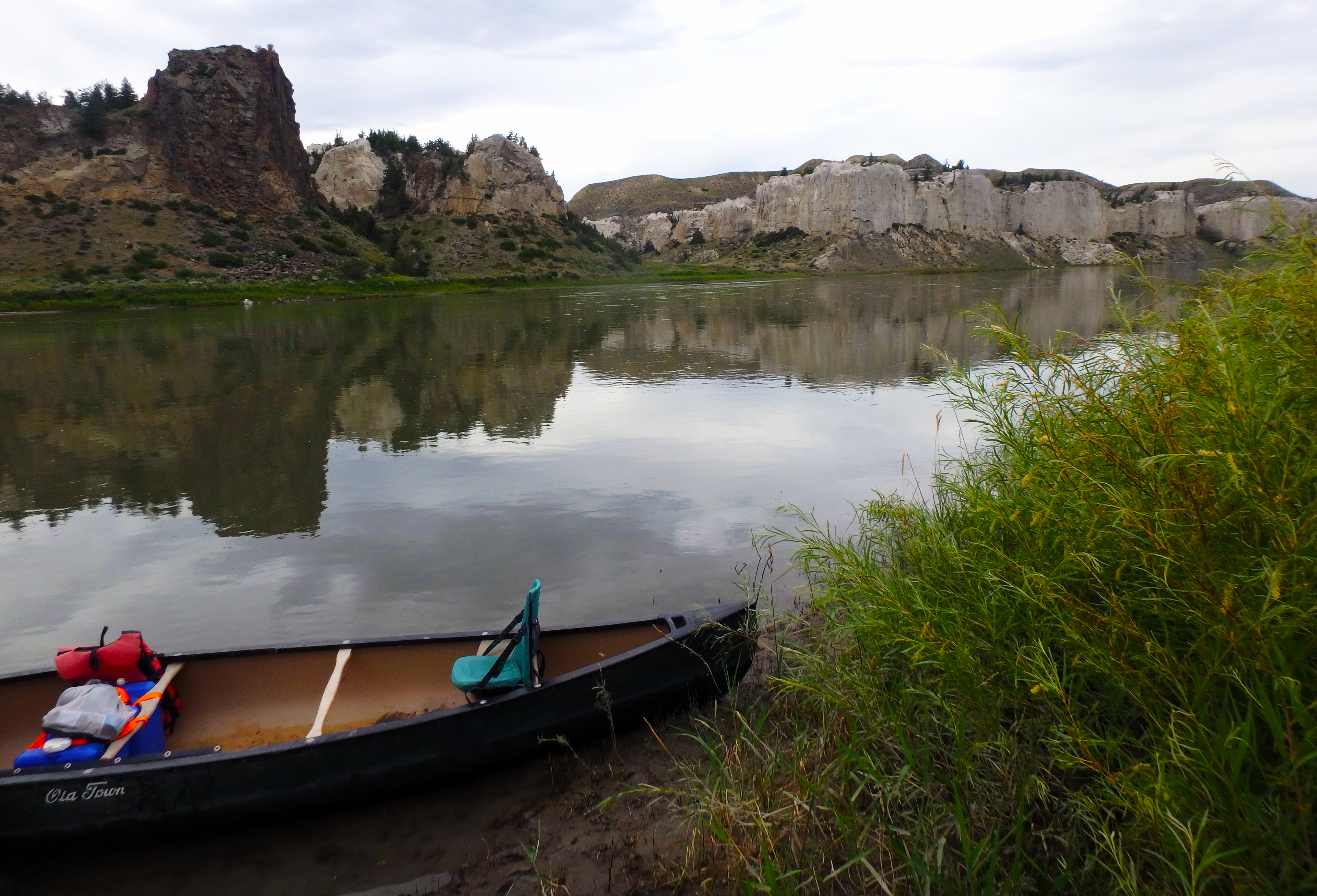 canoe at camp eagle umb a canoe on a river with rocky cliffs in the background