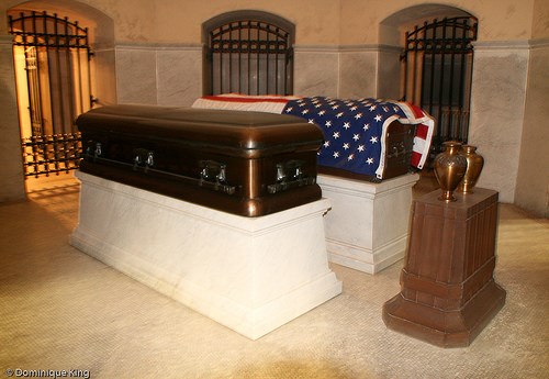 caskets caskets on display with an American draped over it