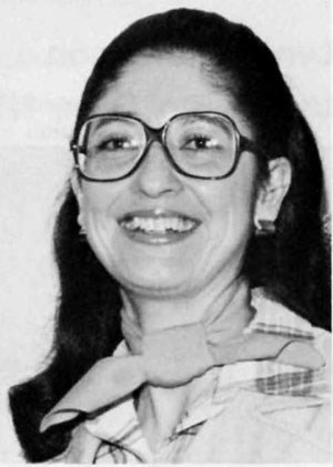 Cecilia Matic, 1978 Cecilia Matic with long dark hair and round glasses smiles at the camera.