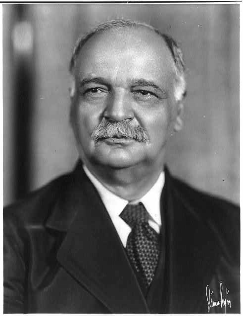 lt= A historic portrait of a man in a suit.