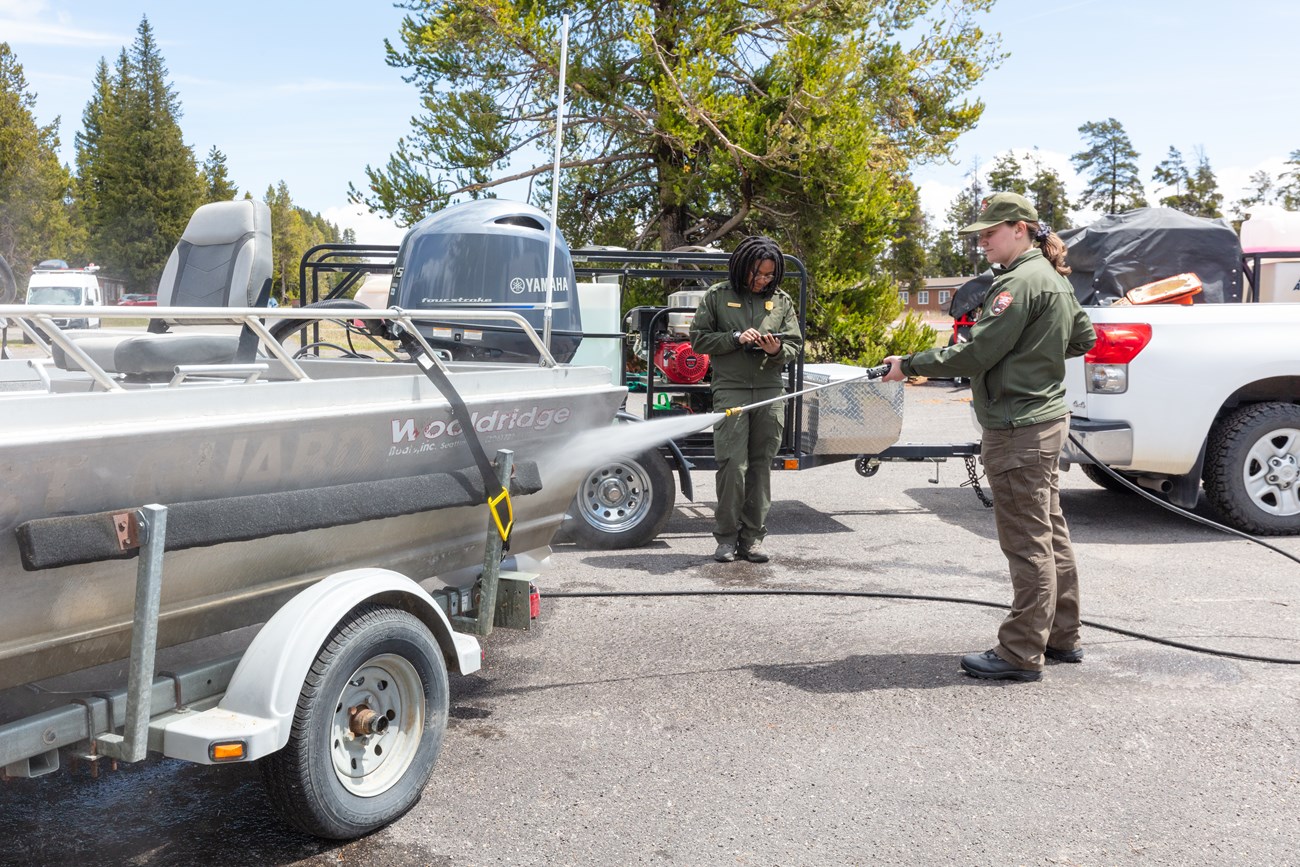 a person power washes a boat