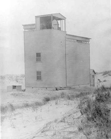 a tall wooden structure housing a searchlight tower