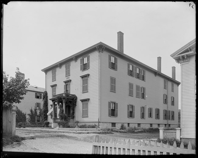 Black and white image of wooden three story house